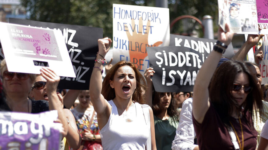 Women wave posters as they march in protest against domestic abuse, in Istanbul July 20, 2014. Turkey, which aspires to join the European Union, has drafted new legislation to try to bring women's rights in line with European standards. A law sent to parliament just last month will toughen sentencing for sexual assault. Officials say the number of shelters has doubled in the past three years and victim support centres have been set up, allowing women like Hayat to receive protection and remain with their ch