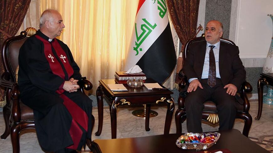 Iraq's Prime Minister-designate Haider al-Abadi (R) meets with Pastor Farouk Yousuf in Baghdad August 21, 2014. REUTERS/Karim Kadim/Pool (IRAQ - Tags: CIVIL UNREST POLITICS RELIGION) - RTR438QY