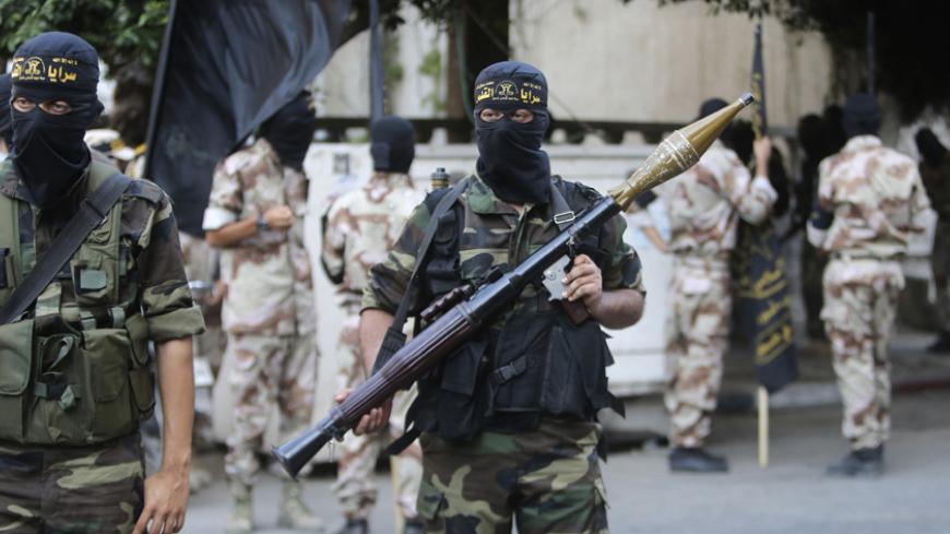 A Palestinian Islamic Jihad militant holds an RPG during a rally celebrating what the militants say was a victory over Israel following a ceasefire in Gaza City August 29, 2014. An open-ended ceasefire, mediated by Egypt, took effect on Tuesday evening. It called for an indefinite halt to hostilities, the immediate opening of Gaza's blockaded crossings with Israel and Egypt, and a widening of the territory's fishing zone in the Mediterranean. Israel launched an offensive on July 8, with the declared aim of 
