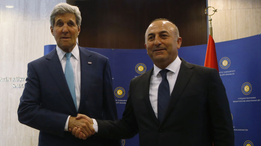U.S. Secretary of State John Kerry (L) and Turkey's Foreign Minister Mevlut Cavusoglu pose before a meeting in Ankara September 12, 2014. Kerry will meet Cavusoglu, as well as Prime Minister Ahmet Davutoglu and President Tayyip Erdogan during his two-day visit to the capital Ankara, the Turkish Foreign Ministry said. REUTERS/Umit Bektas (TURKEY - Tags: POLITICS) - RTR45Z0L
