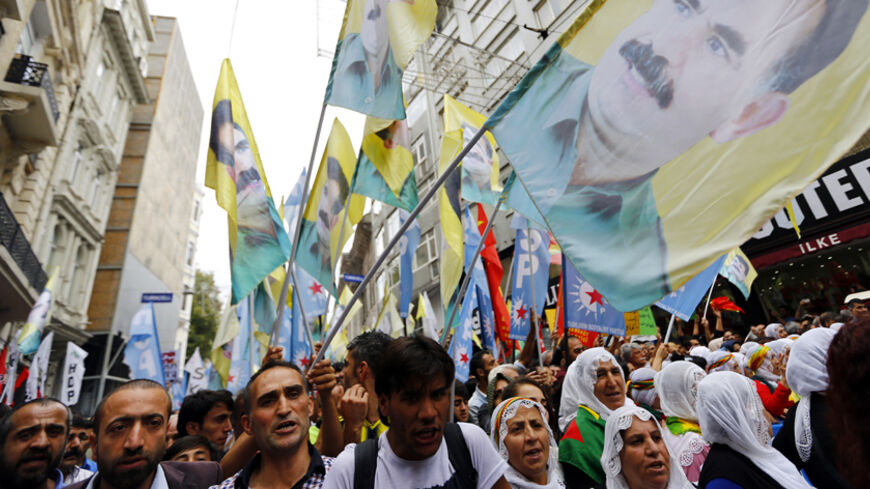 People carry flags bearing the portrait of Abdullah Ocalan, one of the founding members of the militant organisation, the Kurdistan Workers' Party, during a pro-Kurdish protest against Islamic State (IS) militant attacks on Syrian Kurds, in Istanbul September 21, 2014. REUTERS/Murad Sezer (TURKEY  - Tags: POLITICS CIVIL UNREST) - RTR473RF