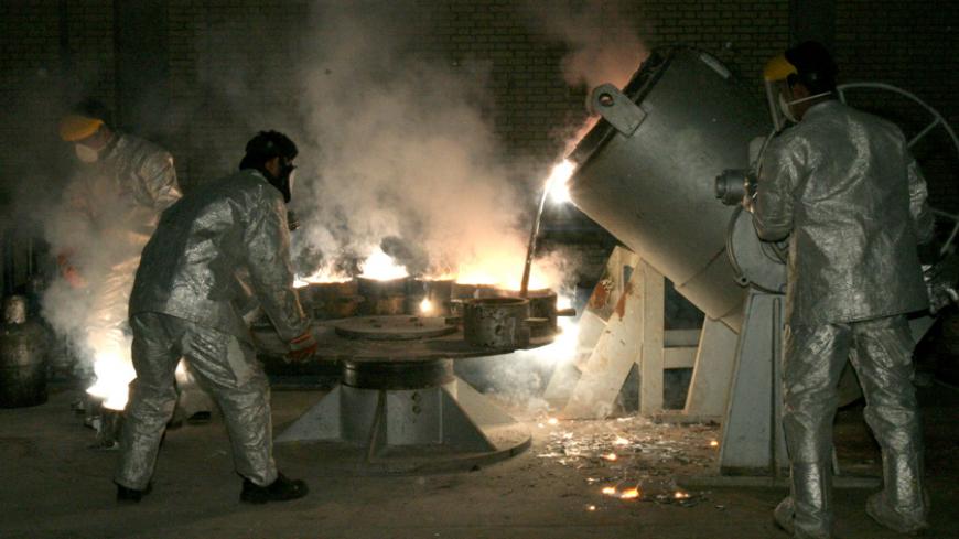 Technicians work at a uranium processing site in Isfahan 340 km (211 miles) south of the Iranian capital Tehran.  Technicians work at a uranium processing site in Isfahan 340 km (211 miles) south of the Iranian capital Tehran March 30, 2005. France, Britain and Germany are considering letting Iran keep nuclear technology that could be used to make bombs, an apparent move towards a compromise with Tehran, diplomats said on Wednesday. REUTERS/Raheb Homavandi - RTR6IQH