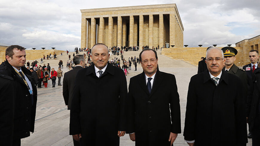France's President Francois Hollande (2nd R), accompanied by Turkey's Minister for EU Affairs and Chief Negotiator Mevlut Cavusoglu (2nd L), leaves following a wreath-laying ceremony at Anitkabir, the mausoleum of modern Turkey's founder Mustafa Kemal Ataturk, in Ankara January 27, 2014. Hollande is in Turkey for a two-day official visit. REUTERS/Murad Sezer (TURKEY - Tags: POLITICS) - RTX17WV2