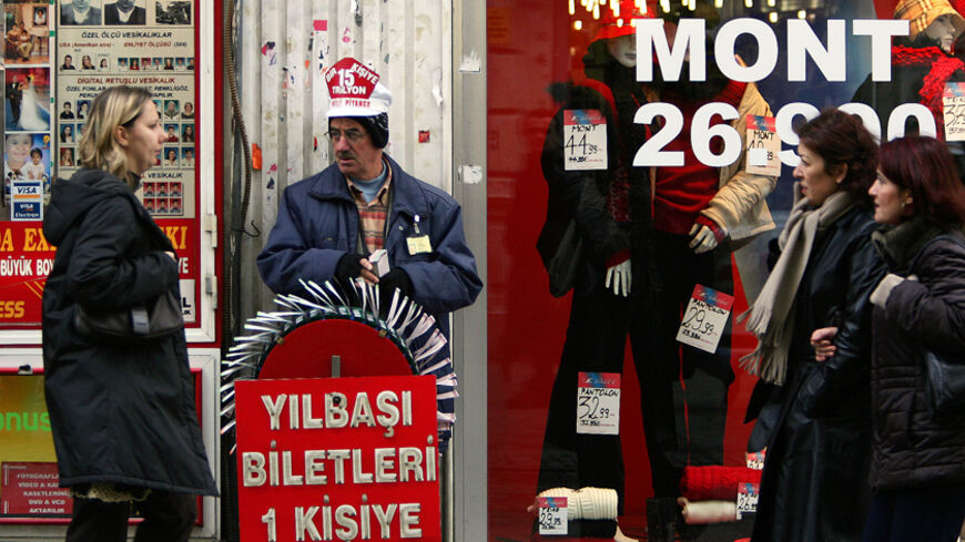 A Turkish woman walks past a national lottery ticket seller offering tickets in Istanbul for the New Year draw with a highest ever prize.  A Turkish woman walks past a national lottery ticket seller offering tickets for the New Year draw with a prize of 15 trillion TL ($10.4 million) for only one person, highest ever in its kind, in central Istanbul's busy shopping district of Beyoglu December 14, 2004. EU leaders are widely expected to agree at a summit on - RTR15CVO