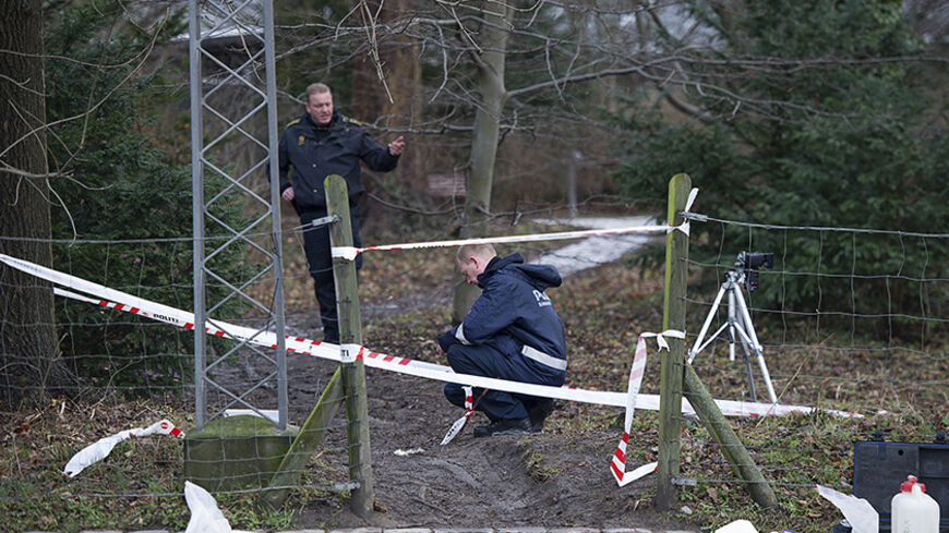 Danish policemen look for clues after an attempted attack on Danish writer Lars Hedegaard in Frederiksberg February 5, 2013. Hedegaard, a critic of Islam, was attacked outside his house in the Pelargonievej neighbourhood, near Copenhagen, by a man disguised as a postman who missed a shot to the head and fled the scene. REUTERS/Claus Bech/Scanpix (DENMARK - Tags: CRIME LAW RELIGION) NO COMMERCIAL OR BOOK SALES. THIS IMAGE HAS BEEN SUPPLIED BY A THIRD PARTY. IT IS DISTRIBUTED, EXACTLY AS RECEIVED BY REUTERS, 