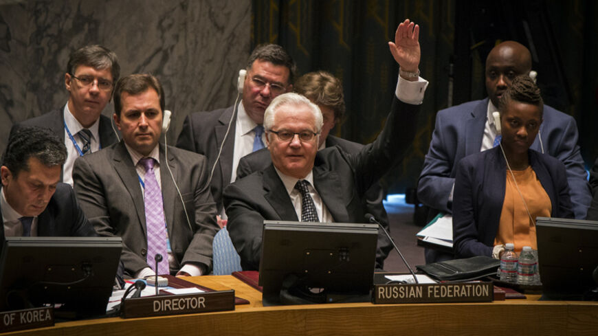 Russia's UN Ambassador Vitaly Churkin votes in the United Nations Security Council against referring the Syrian crisis to the International Criminal Court for investigation of possible war crimes at the U.N. headquarters in New York May 22, 2014. REUTERS/Lucas Jackson (UNITED STATES - Tags: POLITICS) - RTR3QE4L