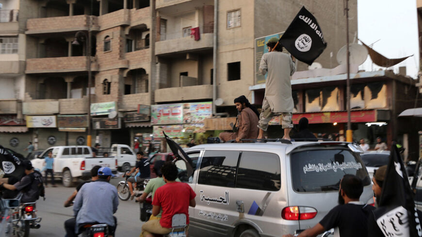 Members loyal to the Islamic State in Iraq and the Levant (ISIL) wave ISIL flags as they drive around Raqqa June 29, 2014. The offshoot of al Qaeda which has captured swathes of territory in Iraq and Syria has declared itself an Islamic "Caliphate" and called on factions worldwide to pledge their allegiance, a statement posted on jihadist websites said on Sunday. The group, previously known as the Islamic State in Iraq and the Levant (ISIL), also known as ISIS, has renamed itself "Islamic State" and proclai