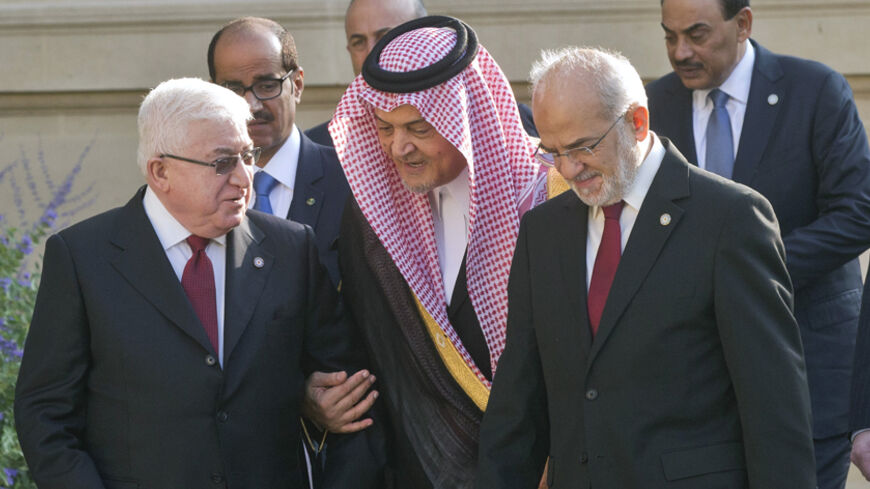 Iraq's President Fouad Massoum (L) talks with Saudi Arabian Foreign Minister Prince Saud al-Faisal (C) and  Iraqi Foreign Minister Ibrahim al-Jaafari as they arrive for a family photo during the International Conference on Peace and Security in Iraq, at the Quai d'Orsay in Paris September 15, 2014.  French President Hollande called on Monday for a global response to counter Islamic State militants during an International conference bringing together about 30 countries to discuss how to cooperate in the figh