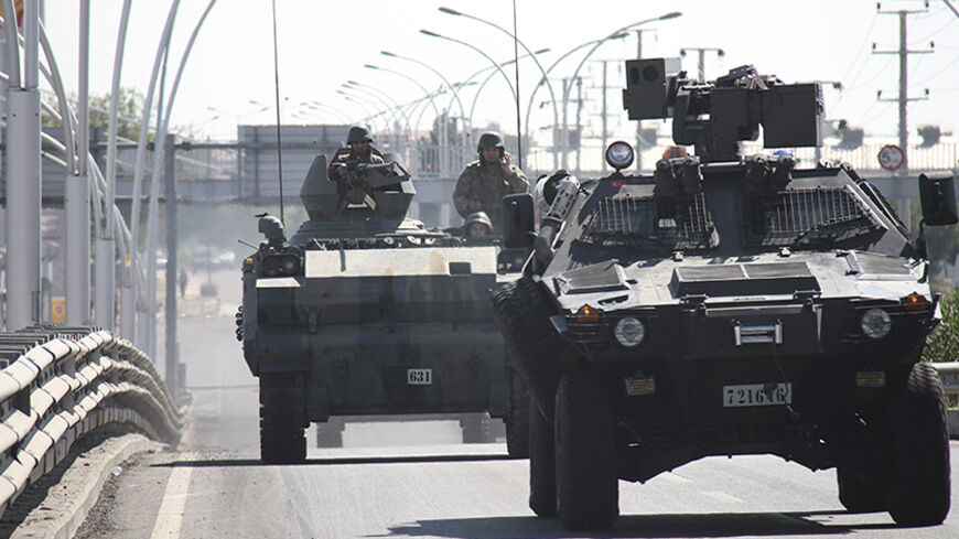 Turkish soldiers in armoured vehicles patrol the streets of Diyarbakir October 8, 2014. At least 12 people died on Tuesday during violent clashes across Turkey, local media reported, as the fate of the besieged Syrian border town of Kobani stirred up decades of tensions with Turkey's Kurdish minority. Violence erupted in Turkish towns and cities mainly in the Kurdish southeastern provinces, as protesters took to the streets to demand the government do more to protect Kobani, a predominantly Kurdish settleme
