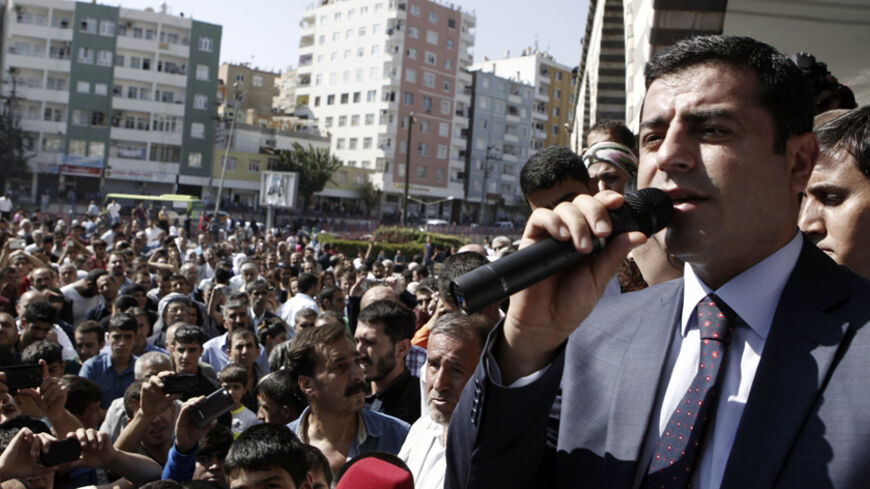 Selahattin Demirtas, co-chair of the HDP, Turkey's leading Kurdish party, addresses his supporters in Diyarbakir October 9, 2014. Islamic State fighters launched a renewed assault on the Syrian city of Kobani on Wednesday night, and at least 21 people were killed in riots in neighbouring Turkey where Kurds rose up against the government for doing nothing to protect their win. REUTERS/Osman Orsal (TURKEY - Tags: POLITICS CIVIL UNREST) - RTR49I8X