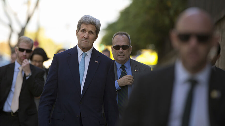 U.S. Secretary of State John Kerry, surrounded by security, walks to meet with French Foreign Minister Laurent Fabius at the Quai d'Orsay in Paris, October 13, 2014. REUTERS/Carolyn Kaster/Pool (FRANCE - Tags: POLITICS) - RTR4A0Y7