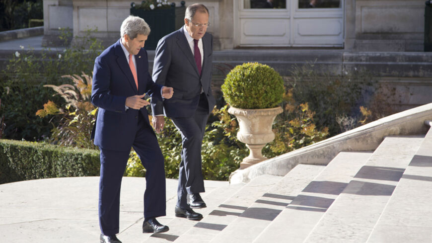 U.S. Secretary of State John Kerry (L) and Russian Foreign Minister Sergey Lavrov talk as they walk into the Chief of Mission Residence in Paris October 14, 2014. REUTERS/Carolyn Kaster/Pool (FRANCE - Tags: POLITICS) - RTR4A5UI