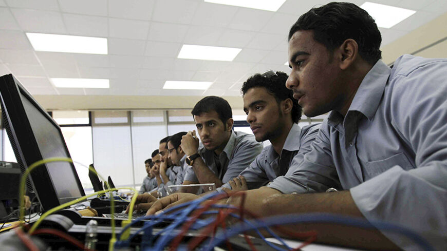 Saudi students attend a class at the Technology College in Riyadh in this October 30, 2010 file photo. The Kingdom of Saudi Arabia sits on more than a fifth of the globe's oil reserves and thanks to high oil prices it has almost tripled its foreign assets to more than $400 billion since 2005. The region's thinkers had a profound influence on the evolving western science of the Middle Ages. But from kindergarten to university, its state education system has barely entered the modern age. Focused on religious