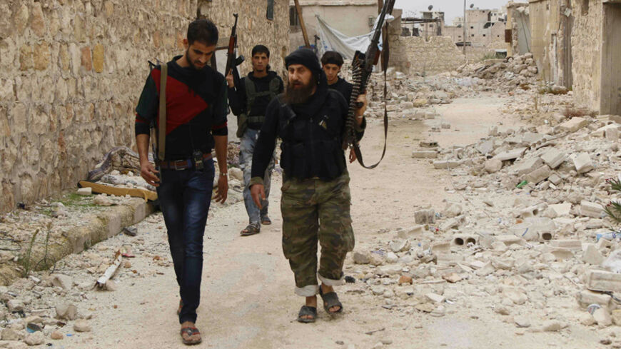 Rebel fighters carrying weapons move towards their positions on the Karm al-Tarab frontline in Aleppo October 30, 2014. REUTERS/Hosam Katan (SYRIA - Tags: POLITICS CIVIL UNREST CONFLICT) - RTR4C6IU