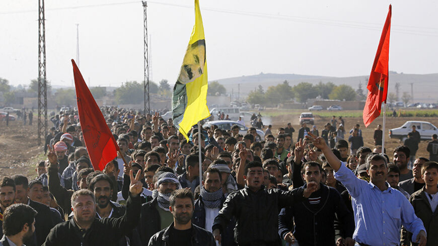 Kurdish civilians march by the Turkish-Syrian border village of Caycara to protest against Islamic State, during a rally in solidarity with the people of the Syrian Kurdish town of Kobani, November 1, 2014.REUTERS/Yannis Behrakis (TURKEY - Tags: CIVIL UNREST MILITARY POLITICS CONFLICT) - RTR4CFSC