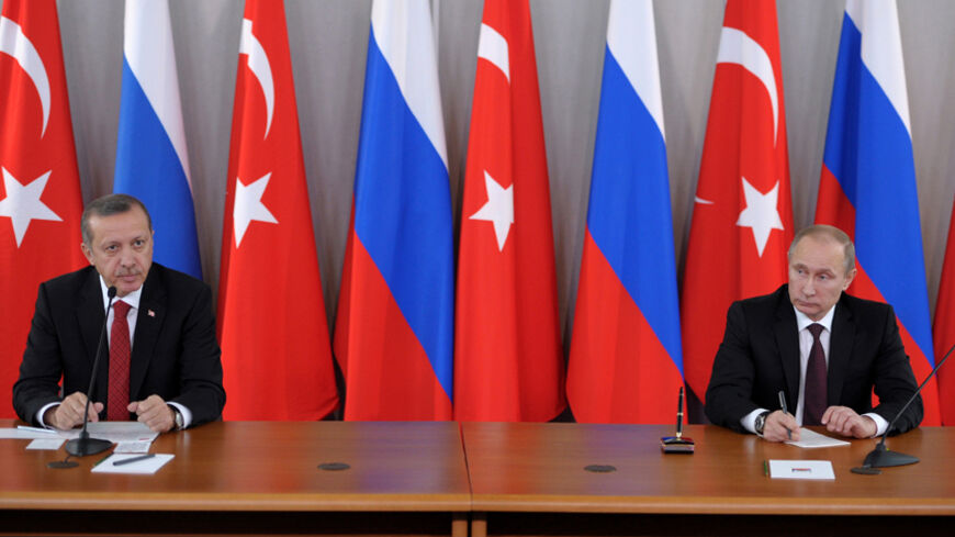 Russian President Vladimir Putin (R) attends a news conference with Turkish Prime Minister Tayyip Erdogan in Strelna near St. Petersburg, November 22, 2013. Putin said on Friday Western states must persuade the Syrian opposition to attend talks with President Bashar al-Assad's government which he said should take place as soon as possible.  REUTERS/Aleksey Nikolskyi/RIA Novosti/Kremlin (RUSSIA - Tags: POLITICS CONFLICT) 

ATTENTION EDITORS - THIS IMAGE HAS BEEN SUPPLIED BY A THIRD PARTY. IT IS DISTRIBUTED, 