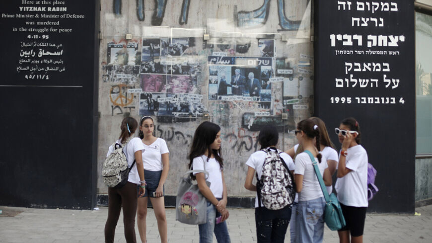 Israeli school children stand next to a memorial marking the site where Prime Minister Yitzhak Rabin was assassinated in Tel Aviv October 20, 2010. On Wednesday Israel marks the 15th anniversary of Rabin's killing by an ultra-nationalist Jewish assassin. REUTERS/Nir Elias (ISRAEL - Tags: POLITICS CIVIL UNREST ANNIVERSARY) - RTXTMUL