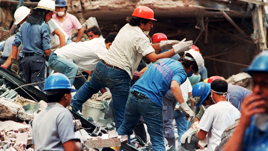 BUENOS AIRES, ARGENTINA - MARCH 18:  Firemen and rescue workers continue to dig through the ruins of the Israeli Embassy early 18 March 1992 in Buenos Aires after a night of search following the 17 March explosion of a powerful car bomb which virtually destroyed the diplomatic building, killing at least 11 people and injuring more than 250. The pro-Iranian Islamic Jihad organization claimed responsability for the attack.  (Photo credit should read DANIEL LUNA/AFP/Getty Images)