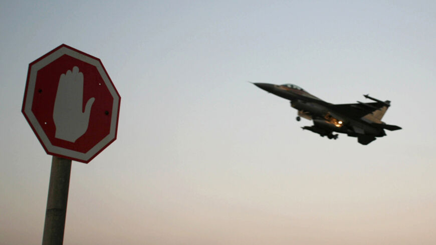 An Israeli Air Force F-16 fighter plane flying above a traffic sign after taking off for a mission in Lebanon from an Israeli Air Force Base in northern Israel in this July 20, 2006 file photo. Israeli warplanes bombed unidentified Syrian targets early on September 6, 2007, causing no damage or casualties, the official Syrian news agency said. Syrian air defences fired at the incoming planes, which crossed into Syria after midnight local time, the agency said. REUTERS/Ammar Awad/Files (ISRAEL) - RTR1THUA
