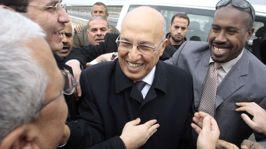 Senior Fatah leader Nabil Shaath (C) is greeted by Palestinians after crossing into the Gaza Strip at the Erez border crossing February 3, 2010. Shaath arrived in Gaza on Wednesday for a first visit since the Islamist group Hamas seized control of the Gaza Strip from the rival Palestinian President Mahmoud Abbas' Fatah movement in 2007.      REUTERS/Ismail Zaydah    (GAZA - Tags: POLITICS IMAGES OF THE DAY) - RTR29SK7