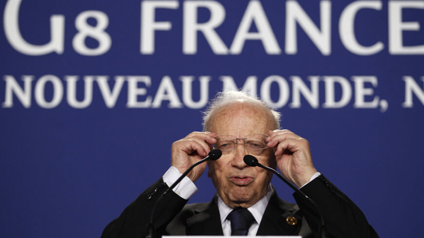 Tunisia's Prime Minister Beji Caid Essebsi adjusts his glasses during a news conference at the G8 summit in Deauville May 27, 2011.  REUTERS/Andrew Winning (FRANCE  - Tags: POLITICS BUSINESS)   - RTR2MYO6