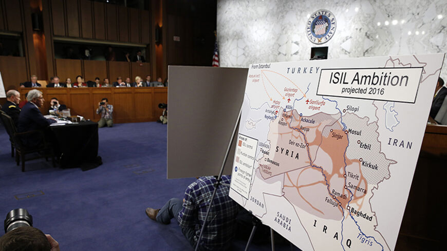 A map showing Islamic State ambition is displayed as U.S. Secretary of Defense Chuck Hagel (L) and Chairman of the Joint Chiefs of Staff Gen. Martin Dempsey testify during the Senate Armed Services Committee hearing on U.S. policy toward Iraq and Syria and the threat posed by the Islamic State on Capitol Hill in Washington September 16, 2014.  REUTERS/Kevin Lamarque  (UNITED STATES - Tags: POLITICS MILITARY) - RTR46GAJ