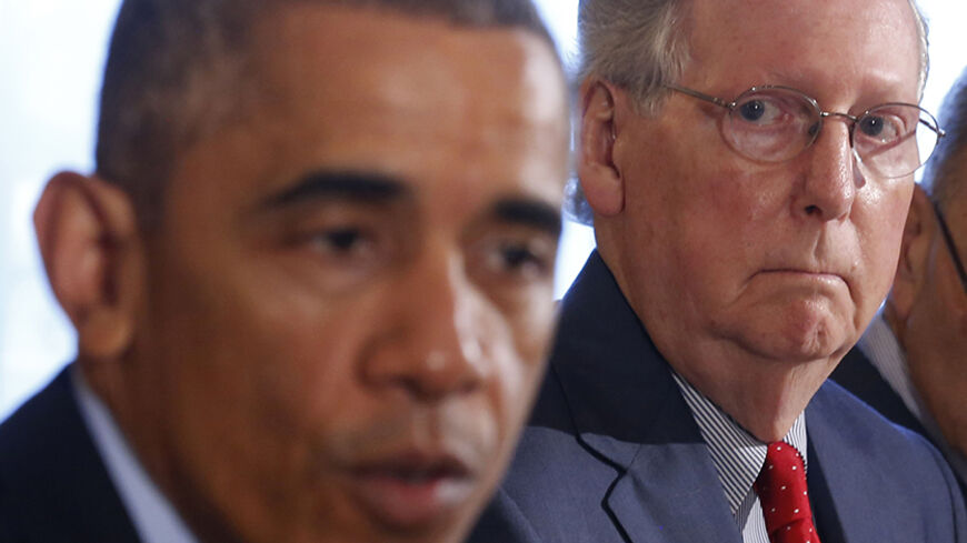 Senate Minority Leader Mitch McConnell listens as U.S. President Barack Obama hosts a luncheon for bi-partisan Congressional leaders in the Old Family Dining Room at the White House in Washington, November 7, 2014.     REUTERS/Larry Downing   (UNITED STATES - Tags: POLITICS) - RTR4DANC