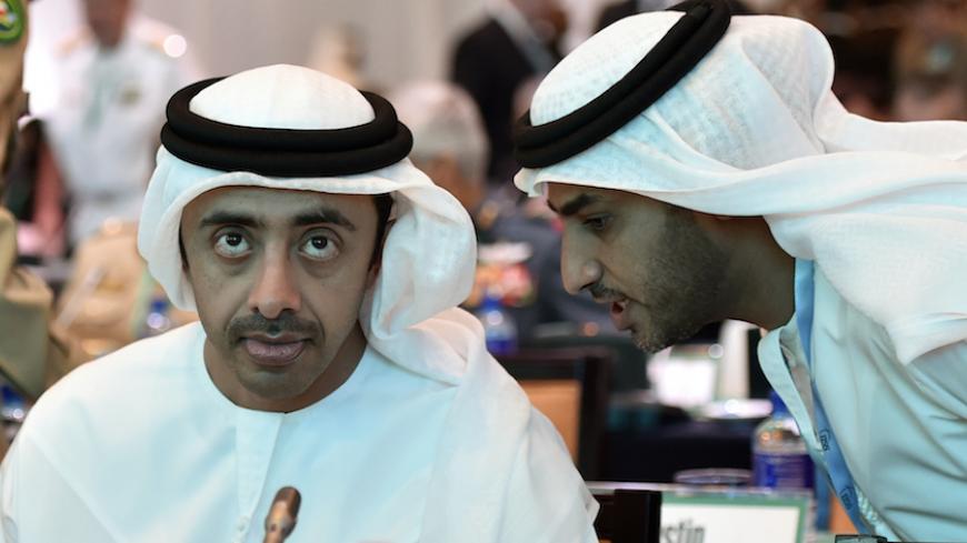 United Arab Emirates' Foreign Minister Sheikh Abdullah bin Zayed Al-Nahyan (L) listens to his personal assistant during the 10th International Institute for Strategic Studies (IISS) Regional Security Summit "The Manama Dialogue" in Manama December 6, 2014. REUTERS/Stringer (BAHRAIN - Tags: POLITICS) - RTR4GYH3