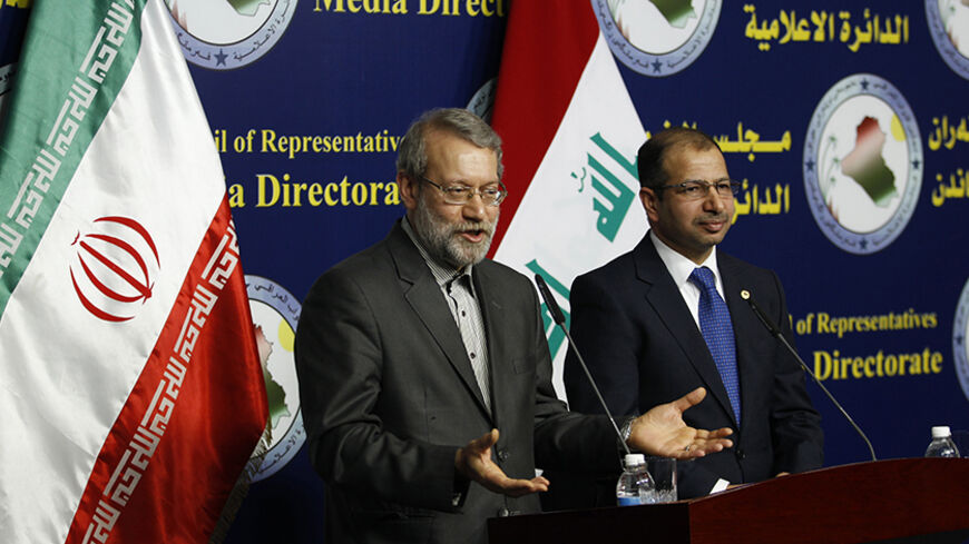 Iran's parliament speaker Ali Larijani (L)and Iraqi parliament speaker Salim al-Jabouri speak during a news conference in Baghdad December 24, 2014. REUTERS/Thaier Al-Sudani (IRAQ - Tags: POLITICS) - RTR4J5WG