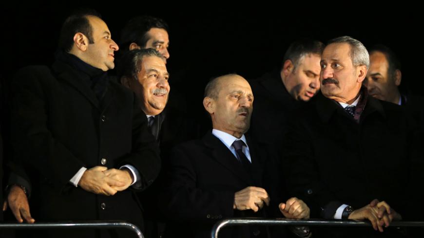 (L-R) Turkey's European Affairs Minister Egemen Bagis, Interior Minister Muammer Guler, Environment and City Planning Minister Erdogan Bayraktar and Economy Minister Zafer Caglayan wait for the arrival of the prime minister at Esenboga Airport in Ankara December 24, 2013. Turkish ministers Caglayan and Guler resigned on Wednesday after their sons were arrested in a corruption investigation that has pitted the government against the judiciary and rattled foreign investors. Guler and Caglayan each had a son a