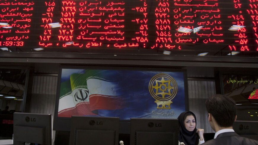 EDITORS' NOTE: Reuters and other foreign media are subject to Iranian restrictions on their ability to report, film or take pictures in Tehran. 

A trader speaks with a stock market official beneath the electronic board at the Tehran stock exchange September 15, 2010. While U.S. diplomats were busy upping Iran's economic punishment over nuclear activities Washington fears are aimed at making a bomb, Iranian shares, which might have been expected to fall, have, instead, gone through the roof. Picture taken S