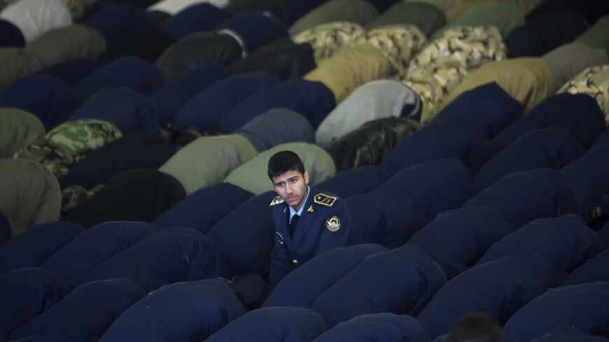 EDITORS' NOTE: Reuters and other foreign media are subject to Iranian restrictions on leaving the office to report, film or take pictures in Tehran.

A member of the Iranian army air force looks up as other members of the air and land force pray during Friday prayers in Tehran February 10, 2012. REUTERS/Morteza Nikoubazl (IRAN - Tags: POLITICS RELIGION MILITARY TPX IMAGES OF THE DAY) - RTR2XM1P