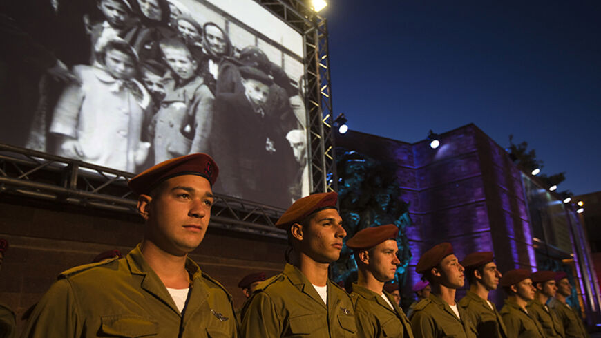 Israeli soldiers stand in formation before the opening ceremony of the annual Holocaust Memorial Day at the Yad Vashem Holocaust Memorial in Jerusalem April 27, 2014. Starting Sunday evening, Israel marks the annual memorial day commemorating the six million Jews killed by the Nazis in the Holocaust during World War Two. REUTERS/Ronen Zvulun (JERUSALEM - Tags: POLITICS ANNIVERSARY) - RTR3MTXI