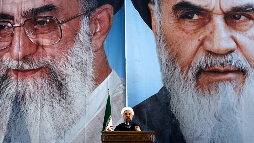 Iranian President Hassan Rouhani delivers a speech under portraits of Iran's supreme leader, Ayatollah Ali Khamenei (L) and Iran's founder of the Islamic Republic, Ayatollah Ruhollah Khomeini (R), on the eve of the 25th anniversary of the Islamic revolutionary leader Ayatollah Ruhollah Khomeini's death, at his mausoleum in a suburb of Tehran on June 3, 2014. AFP PHOTO / ATTA KENARE        (Photo credit should read ATTA KENARE/AFP/Getty Images)
