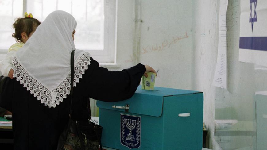 An Israeli-Arab voter drops a ballot into a ballot box during voting in East Jerusalem, February 6, 2001. Most Israeli-Arabs are expected to abstain from voting in a protest against the 13 Israeli-Arabs who were killed during the recent 'Intifada' or uprising against Israel. Ariel Sharon appeared poised for a stunning political victory over Prime Minister Ehud Barak as voters began casting ballots Tuesday in an election seen as a referendum on Israel's relationship with the Palestinians.

EH/WS - RTR15LTJ