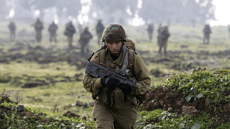 An Israeli soldier from the Golani brigade takes part in training near the city of Katzrin in the Golan Heights January 19, 2015. An Israeli helicopter strike in Syria killed a commander from Lebanon's Hezbollah and the son of the group's late military leader Imad Moughniyah, Hezbollah said, in a major blow that could lead to reprisal attacks.The strike hit a convoy carrying Jihad Moughniyah and commander Mohamad Issa, known as Abu Issa, in the province of Quneitra, near the Israeli-occupied Golan Heights, 