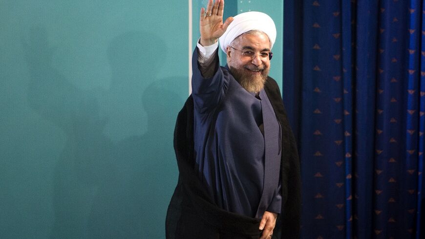 Iranian President Hassan Rouhani waves as he leaves a press conference in Tehran on August 30, 2014. Iran accused the United States of duplicity for imposing new sanctions on organisations linked to Tehran's nuclear programme, despite long-running but active negotiations to end the standoff. AFP PHOTO/ BEHROUZ MEHRI        (Photo credit should read BEHROUZ MEHRI/AFP/Getty Images)