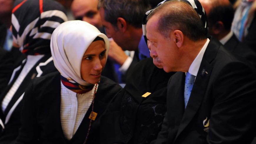 Prime Minister of Turkey, Recep Tayyip Erdogan (R) speaks with her daughter Sumeyye Erdogan, during the 125th Session of the International Olympic Committee (IOC), in Buenos Aires, on September 7, 2013. The host of the 2020 Olympic Games will be contested between Tokyo and Istanbul in a second round of voting after Madrid was eliminated in dramatic fashion from the race after the first round of voting by International Olympic Committee (IOC) members.  AFP PHOTO / DANIEL GARCIA        (Photo credit should re