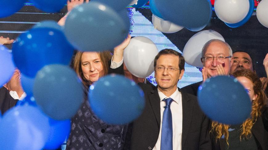 Israeli Labour Party leader Isaac Herzog (C-R) and former justice minister and Hatnuah party leader Tzipi Livni (L) wave during an election campaign meeting in Tel Aviv, on January 25, 2015 ahead of the March 17 general elections. Opposition Labour party head Isaac Herzog and Livni have made an alliance to contest Israel's snap general election. Most Israelis would like to see Prime Minister Benjamin Netanyahu replaced after March elections but, paradoxically, he is seen as most suitable for the job, an opi