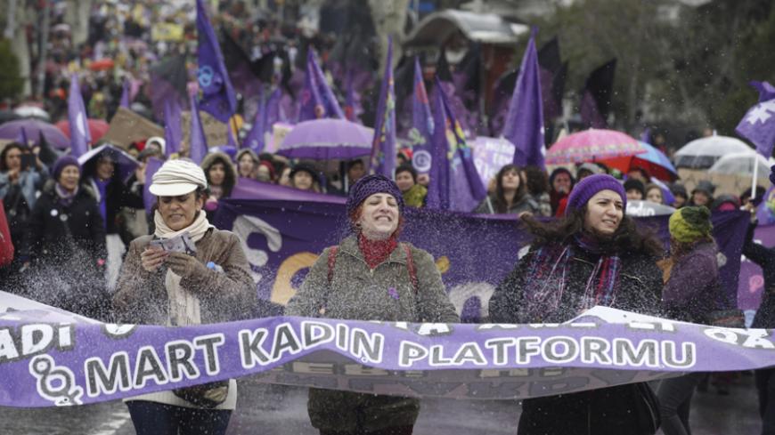 People hold a banner as they protest against the government and violence against women, a day after International Women's Day in Istanbul March 9, 2014. On March 8 activists around the globe celebrate International Women's Day, which dates back to the beginning of the 20th Century and has been observed by the United Nations since 1975. The UN writes that it is an occasion to commemorate achievements in women's rights and to call for further change. The banner reads, "8 march women unions". REUTERS/Osman Ors