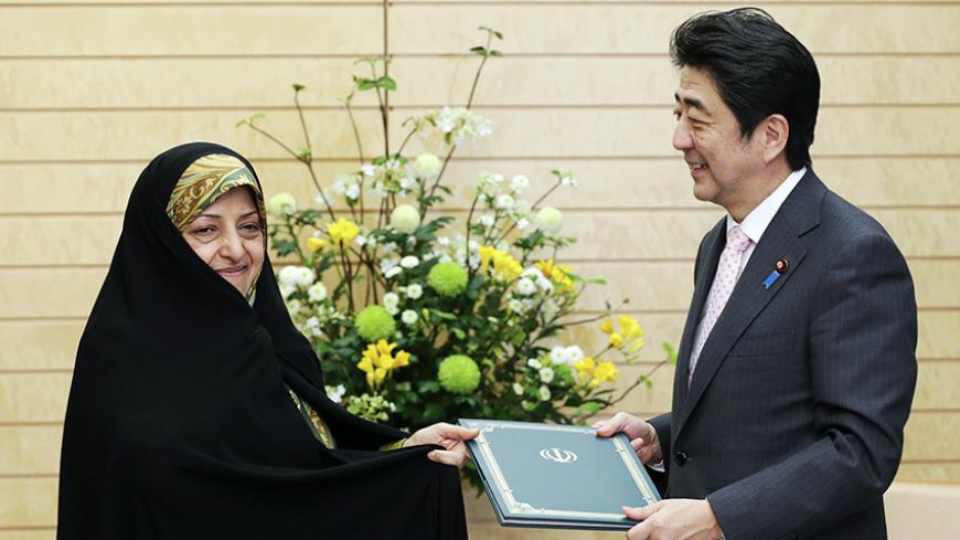 Masoumeh Ebtekar, Vice President of the Islamic Republic of Iran hands a letter from Iran's President Hassan Rouhani to Japan's Prime Minister Shinzo Abe (R) at the latter's official residence in Tokyo April 3, 2014. REUTERS/Kimimasa Mayama/Pool (JAPAN - Tags: POLITICS) - RTR3JQOG