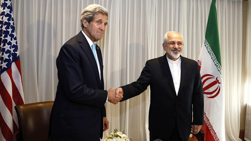 U.S. Secretary of State John Kerry shakes hands with Iranian Foreign Minister Mohammad Javad Zarif before a meeting in Geneva January 14, 2015. Zarif said on Wednesday that his meeting with Kerry was important to see if progress could be made in narrowing differences on his country's disputed nuclear program.  REUTERS/Rick Wilking (SWITZERLAND - Tags: POLITICS) - RTR4LDWF