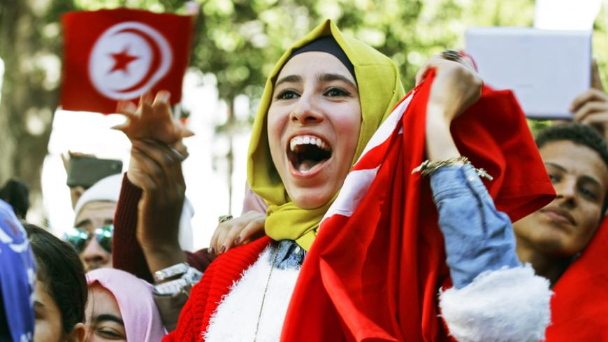 A woman shouts slogans during celebrations marking the fourth anniversary of Tunisia's 2011 revolution, in Habib Bourguiba Avenue in Tunis January 14, 2015. REUTERS/Anis Mili (TUNISIA - Tags: POLITICS ANNIVERSARY SOCIETY) - RTR4LGKF