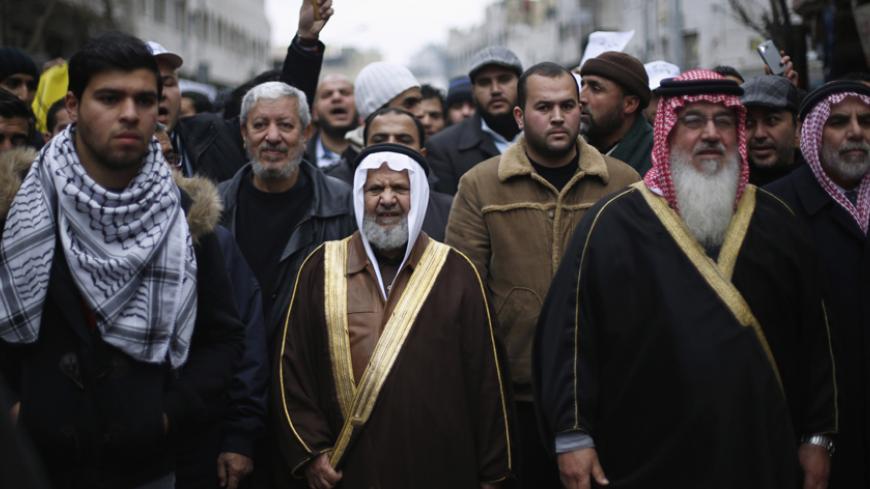 Leader of Jordan's Muslim Brotherhood Sheikh Hammam Said (C), takes part during a protest against satirical French weekly newspaper Charlie Hebdo, which featured a cartoon of the Prophet Mohammad as the cover of its first edition since an attack by Islamist gunmen, held by the Islamic Action Front and others after the Friday prayer in Amman January 16, 2015. REUTERS/Muhammad Hamed (JORDAN - Tags: POLITICS RELIGION MEDIA CIVIL UNREST) - RTR4LQ7O