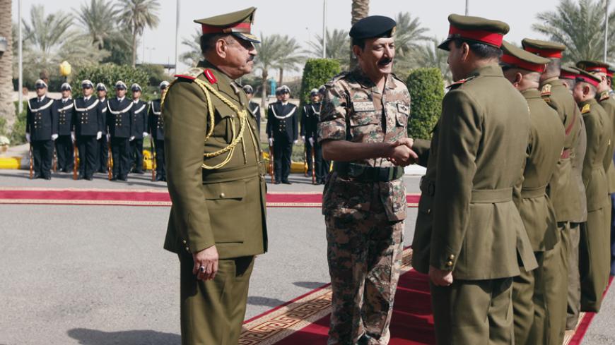 Jordanian Armed Forces Chief of Staff General Mashal Al Zaben (C) shakes hands with Iraqi military officers at the Defence Ministry in Baghdad February 11, 2015. Zaben held talks in Baghdad with his Iraqi counterpart as Arab states continued their attacks on Islamic State (IS) militants occupying chunks of Iraq and Syria.  REUTERS/Ahmed Saad (IRAQ - Tags: CIVIL UNREST POLITICS CONFLICT MILITARY) - RTR4P57F