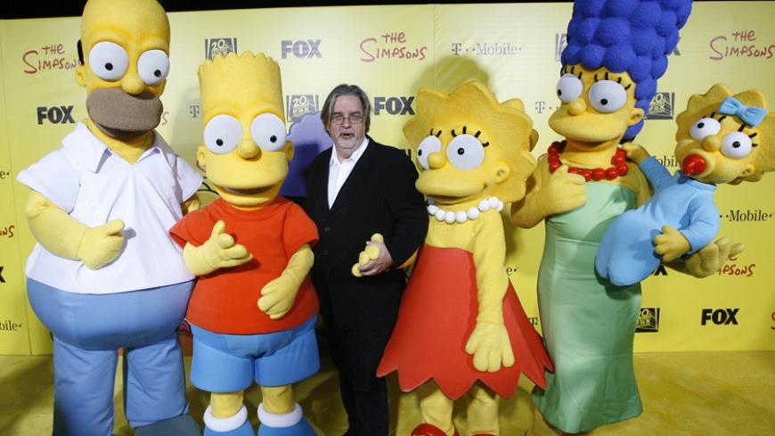 Matt Groening (C), creator of The Simpsons, poses with characters from the show (L-R) Homer, Bart, Lisa, Marge and Maggie at the 20th anniversary party for the television series at Barker hangar in Santa Monica, California October 18, 2009.    REUTERS/Mario Anzuoni   (UNITED STATES ENTERTAINMENT) - RTXPRYH