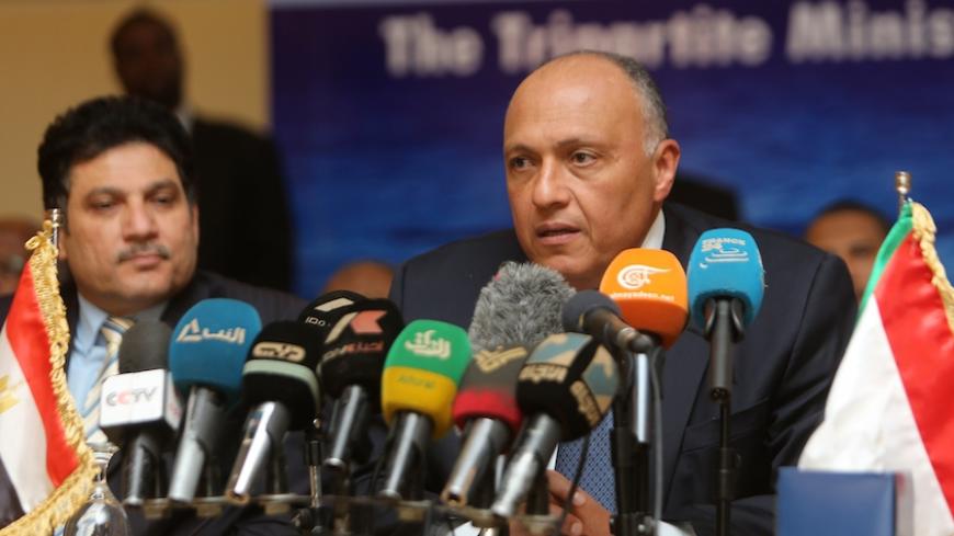 Egypt's foreign minister Sameh Shoukri speaks during a press conference with his Sudanese and Ethiopian counterparts in the early hours of March 6, 2015, on the sidelines of meetings in the Sudanese capital Khartoum, to announce they had reached an agreement on the sharing of Nile waters and Ethiopia's Grand Renaissance Dam. The principles of the use of the eastern Nile Basin and the Ethiopian Renaissance Dam will be submitted to the heads of the three states for approval. AFP PHOTO / ASHRAF SHAZLY        (