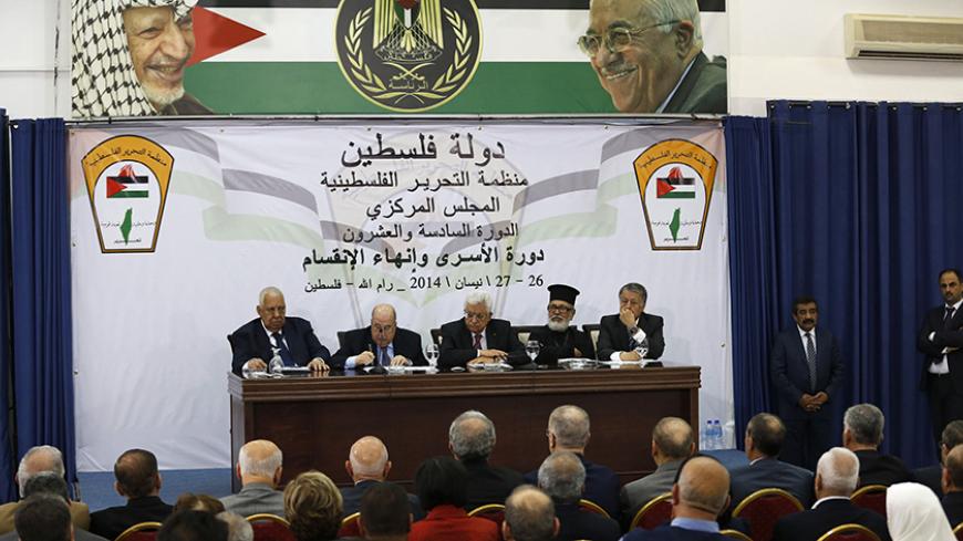 Palestinian President Mahmoud Abbas (C) attends a meeting with the Palestinian Liberation Organization's (PLO) central council in the West Bank City of Ramallah April 26, 2014. Abbas said on Saturday he was still ready to extend stalled peace talks with Israel, as long as it met his long-standing demands to free prisoners and halt building on occupied land. REUTERS/Mohamad Torokman (WEST BANK - Tags: POLITICS) - RTR3MPN5