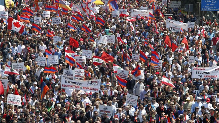 Lebanese of Armenian descent carry banners as they wave Lebanese and Armenian flags during a march from Bourj Hammoud to downtown Beirut's Martyrs Square, April 24, 2013, to mark the 98th anniversary of the mass killing of Armenians in the Ottoman Empire in 1915. REUTERS/Sharif Karim (LEBANON - Tags: POLITICS CIVIL UNREST) - RTXYXYB