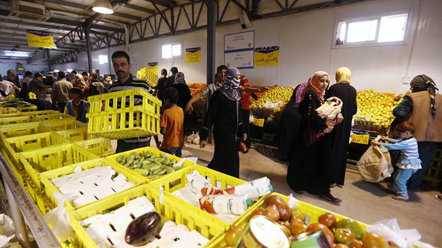 Syrian refugees shop with their humanitarian aid vouchers at the Al Zaatari refugee camp in the Jordanian city of Mafraq, near the border with Syria March 11, 2015. Nearly four million people have fled Syria since 2011, when anti-government protests turned into a violent civil war. Jordan says it is sheltering around 1.3 million refugees.  REUTERS/Muhammad Hamed (JORDAN - Tags: CIVIL UNREST CONFLICT SOCIETY IMMIGRATION FOOD) - RTR4SZBV
